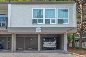 A car is parked in the parking lot of a building